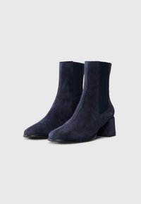 Navy blue suede ankle boots with a pointed toe, elastic side panels, and a chunky heel. Soft texture with minimal detailing.