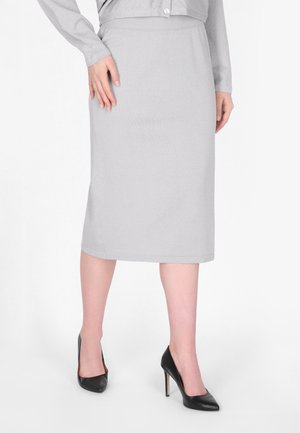 Grijze knielange rok van zacht materiaal met een gladde textuur en een aansluitende tailleband. Gecombineerd met zwarte hoge hakken.