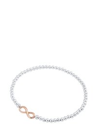 Silver beadarmband med en slät yta, med ett hänglås i roséguld som föreställer en oändlighetssymbol. Enkelt cirkulärt mönster, lämpligt för vardagsbruk.