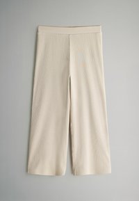 Beige gerippte Hose im weit geschnittenen Design mit einem glatten elastischen Bund und einem sauberen Finish entlang des Saums und der Nähte.