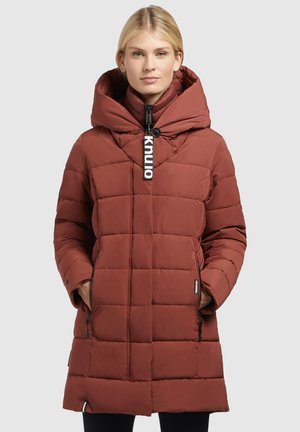 Rust-colored padded parka with a large hood, zipper closure, and side pockets; features a rectangular quilted pattern and logo accent.