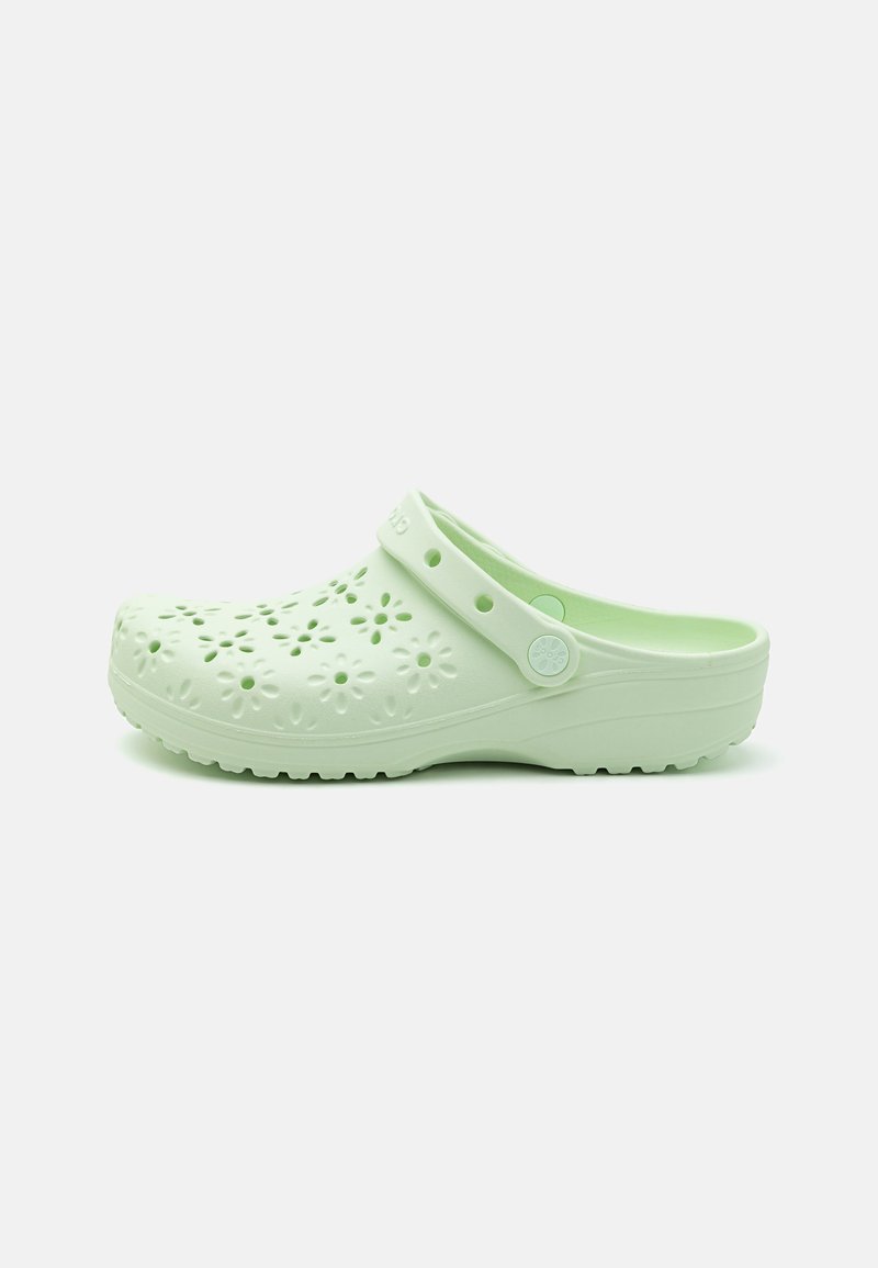 Light green clogs with floral cutouts, made of durable plastic. Features a back strap and textured sole for grip.