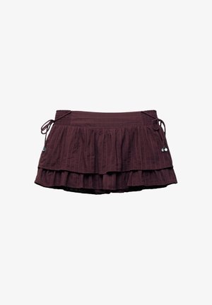 Maroon layered skirt with a ruffled design, featuring a smocked waistband and drawstring sides for adjustable fit. Textured fabric.