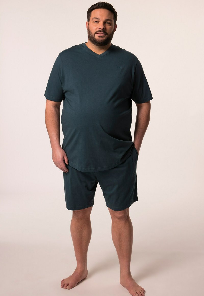 Maglietta a maniche corte a V di colore verde scuro e pantaloni corti abbinati, realizzati in un tessuto morbido, con un taglio rilassato e tasche laterali.