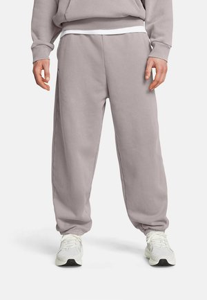 Light grey sweatpants with elastic cuffs and waist, featuring a smooth texture and relaxed fit, paired with white athletic shoes.
