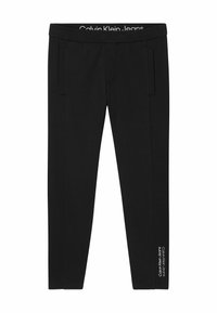 Pantaloni jogger neri in tessuto morbido, con ampia cintura elastica con logo e tasche laterali, vestibilità slim che si restringe alle caviglie.