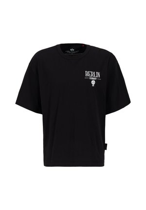 Zwarte katoenen T-shirt met een oversized pasvorm. Heeft witte tekst "BERLIN" en een ballonafbeelding, korte mouwen en een ronde halslijn.