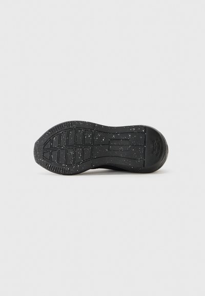 Black sneaker sole with a textured pattern, featuring a speckled design. Durable rubber material with a smooth finish and pronounced grip.