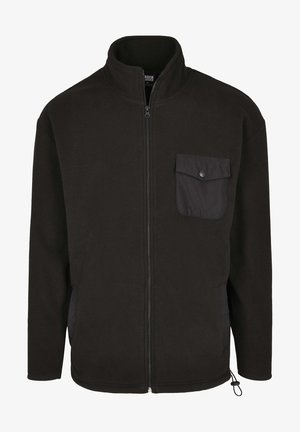 Veste polaire noire avec un col haut, une fermeture éclair à l'avant et une poche à pression. Présente des poches latérales et un cordon de serrage à l'ourlet.