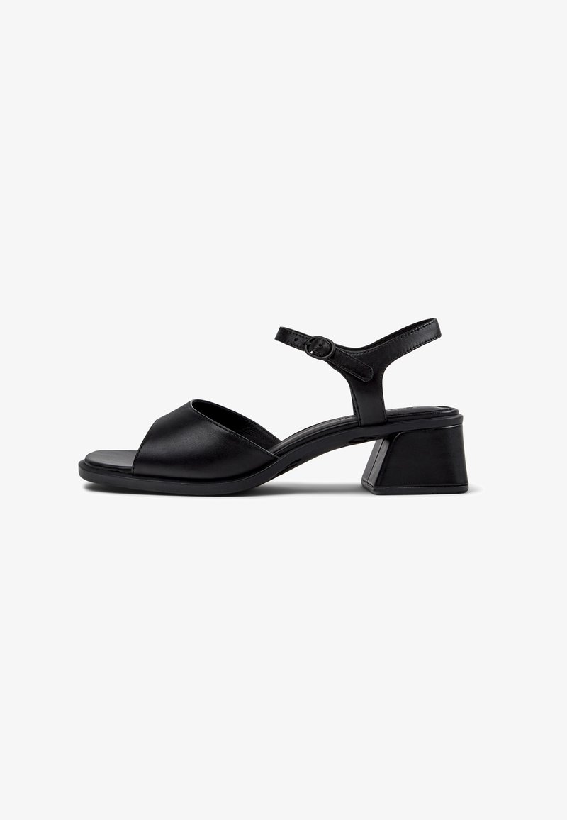 Black leather sandals with an open toe, ankle strap, and a block heel. The sole is flat and the design is minimalist.