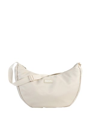 Beige hobo bag made of textured nylon, featuring an adjustable strap and a stitched logo patch. Rounded shape with a zip closure.