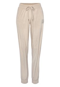 Lichtbeige joggers met een zachte textuur, elastische tailleband en verstelbare trekkoord. Voorzien van zijzakken en een subtiele print op één been.
