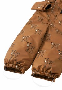 Brown fabric overall with a pattern of deer silhouettes; features elastic cuffs and a front flap for warmth and protection from elements.