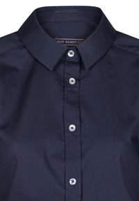 Marineblauwe button-up shirt met een klassieke kraag, vijf knopen en een gladde stofstructuur. Etiket zegt "Felix Hardy."
