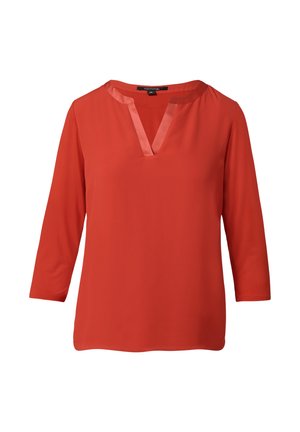 Red blouse with three-quarter sleeves, a V-neckline, and satin trim along the neckline. Smooth fabric texture, simple design.
