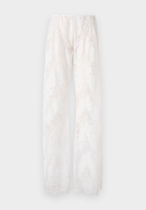 Wide, flowy white pants made of lace fabric with a floral pattern, featuring an elastic waistband and scalloped edges at the hem.