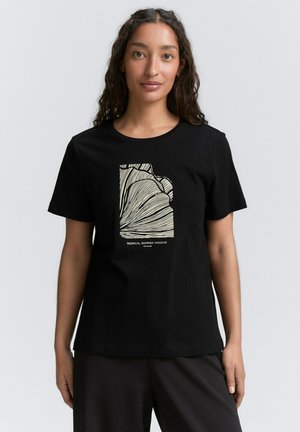 T-shirt en coton noir avec un design graphique de lignes dans une couleur claire, portant le texte "PARADIS TROPICAL D'ÉTÉ" en bas.