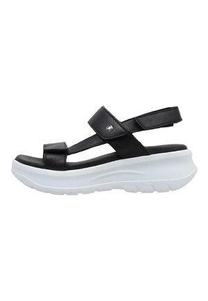 Sandalias de cuero negro con correas ajustables, plantilla blanca y suela texturizada. Presenta un acento plateado en la correa.