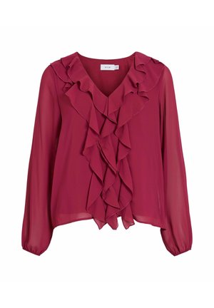 Vinröd blus med långa ärmar, V-ringning och kaskadliknande volanger längs framsidan. Tillverkad av lätt tyg med en slät textur.
