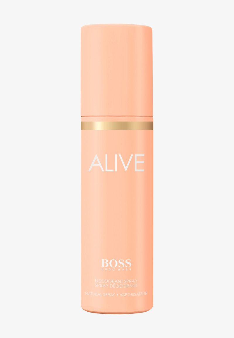 Lata cilíndrica de desodorante en spray color durazno con banda dorada, etiquetada con "ALIVE" y "BOSS HUGO BOSS" sobre un fondo blanco.