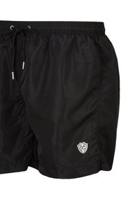 Zwarte zwembroek van nylon, met een elastische tailleband met koord, zijzakken en een klein geborduurd logo op de zoom.