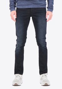 Jeans de un azul oscuro con un ajuste slim, confeccionados en tejido de denim. Presentan un ligero desgaste, cinco bolsillos y un diseño clásico de cremallera.