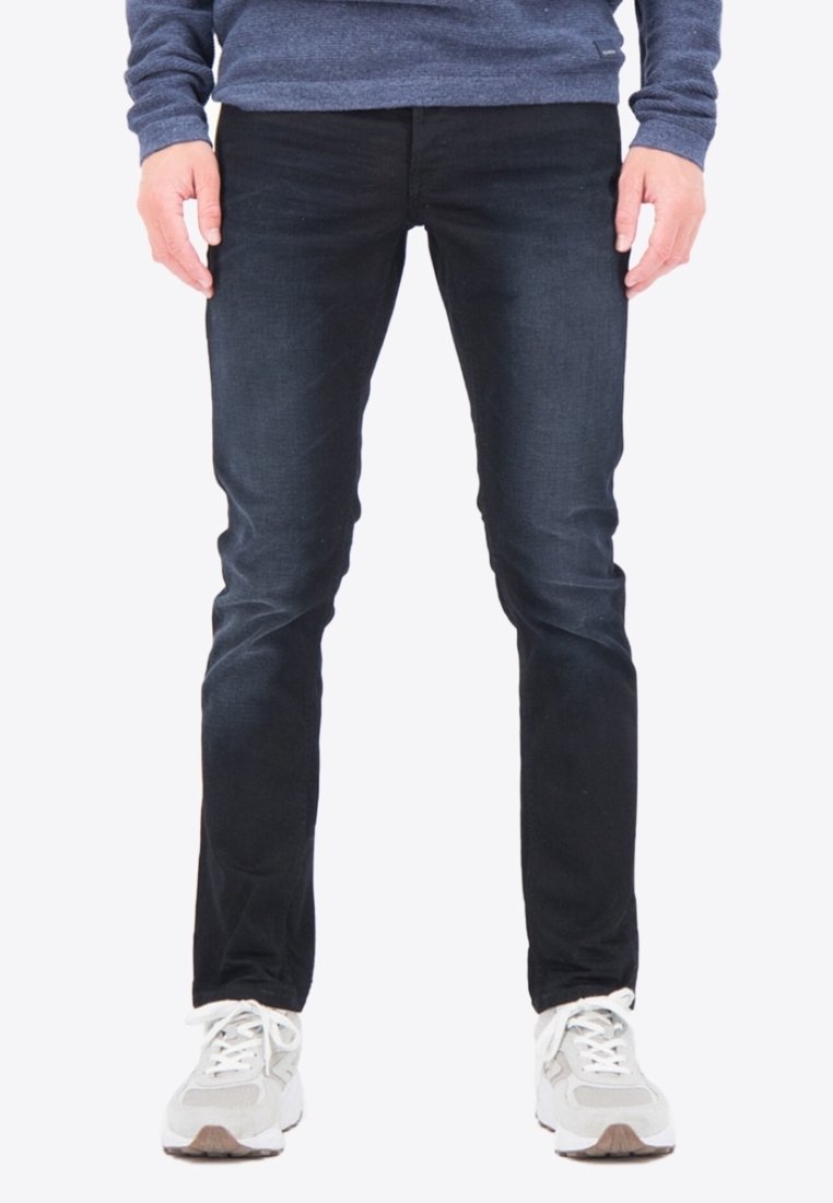 Jeans de un azul oscuro con un ajuste slim, confeccionados en tejido de denim. Presentan un ligero desgaste, cinco bolsillos y un diseño clásico de cremallera.