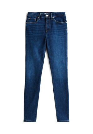 Mørkeblå skinny jeans med knaplukning foran, lynlås, bæltestropper og fem-lomme design, lagt fladt på hvid baggrund.