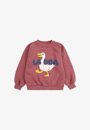 Rose-colored sweatshirt with long sleeves. Features a white duck graphic and the text "LA OCA" in blue. Soft texture, ribbed cuffs and hem.
