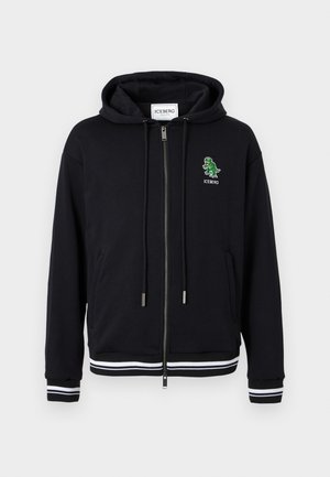 Hoodie zippé noir avec cordons, poignets et ourlet à rayures blanches, et petit logo dinosaure vert avec le texte "ICEBERG" sur le côté gauche de la poitrine.