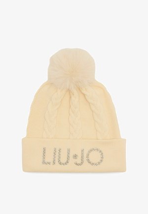 Knit beige beanie with cable pattern, topped with a faux fur pom-pom. Features "LIU•JO" logo in rhinestones on the cuff.