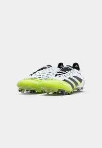 Pair of white and neon yellow Adidas soccer cleats with black stripes, positioned side by side on a plain background.