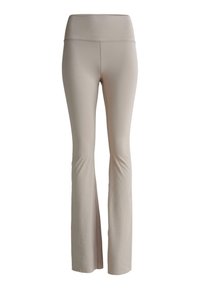 Beige vida leggings gjorda av de flesta sträckmaterial. Hög midja med subtilt varumärke. Slät yta utan synliga sömmar eller mönster.