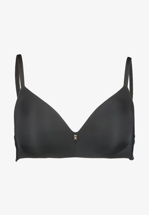 Crna soft-cup grudnjak s V-izrezom, podesivim naramenicama i malim zlatnim detaljem u središtu. Glatka tekstura tkanine.