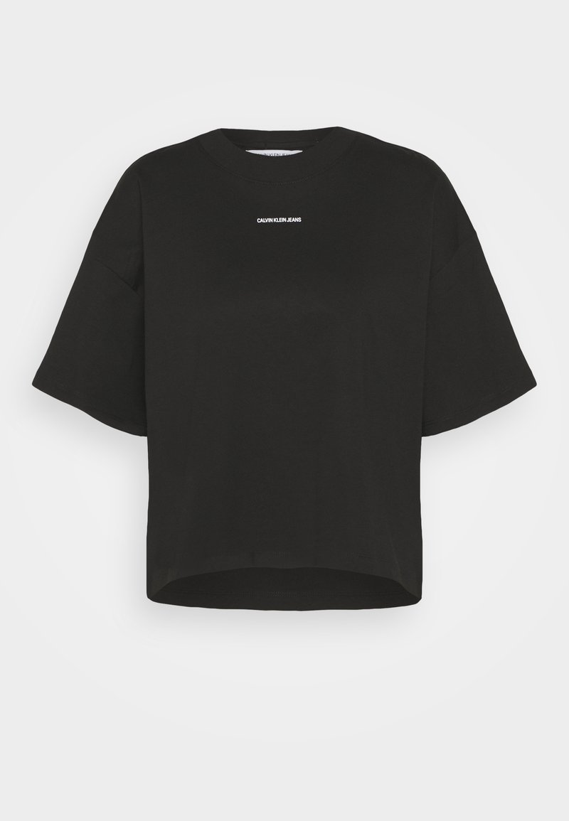T-shirt noir à manches courtes, raccourci, en coton, avec un col rond et le logo blanc "CALVIN KLEIN JEANS" centré sur la poitrine.
