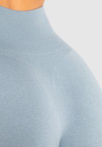 Lichtblauw hoge hals top met een gladde, rekbare textuur. Bevat ribstof en een strakke pasvorm, geschikt voor sportkleding.