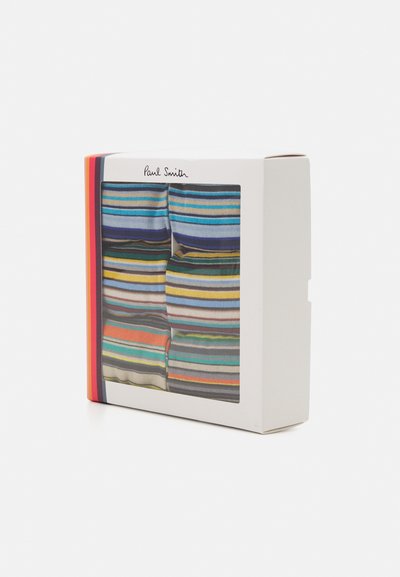 Striped socks in a box, displaying various colors including blue, orange, and green. The packaging is white with a clear front.