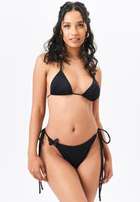 Black bikini set featuring a triangle top with thin straps and a low-rise bottom with ties and a butterfly accent on the side.