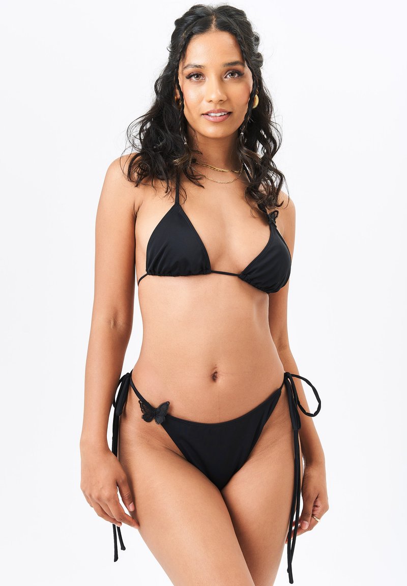 Black bikini set featuring a triangle top with thin straps and a low-rise bottom with ties and a butterfly accent on the side.