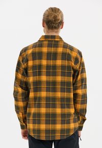Langarm geruite shirt in oranje en donkergroen patroon. Gemaakt van een zachte stof, heeft een kraag en knoopmanchetten.