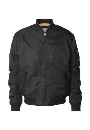 Veste bomber noire avec fermeture éclair à l'avant, col et poignets côtelés, deux poches à rabat à l'avant, et une petite poche zippée sur la manche gauche.