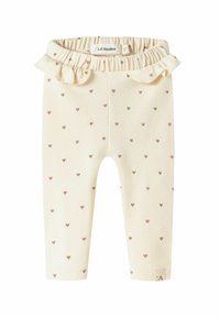 Lichtcrème leggings met kleine, verspreide hartjes in roze en bruin. Voorzien van een gerimpelde tailleband. Gemaakt van zacht, rekbaar materiaal.