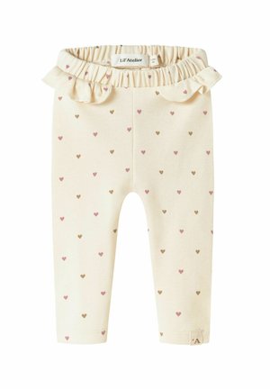 Leggings en crème clair avec de petits cœurs dispersés en rose et marron. Dotés d'une ceinture froncée. Fabriqués en tissu doux et extensible.