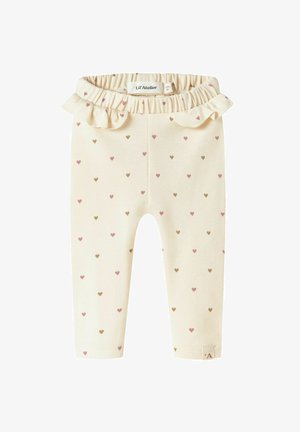 Light cream leggings with small, scattered hearts in pink and brown. Features a ruffled waistband. Made from soft, stretchy fabric.