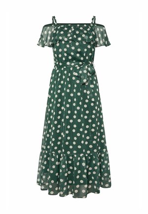 Robe à pois verts avec des manches dénudées, un col à volants, une ceinture à nouer et un ourlet évasé. Fabriquée en tissu léger et texturé.