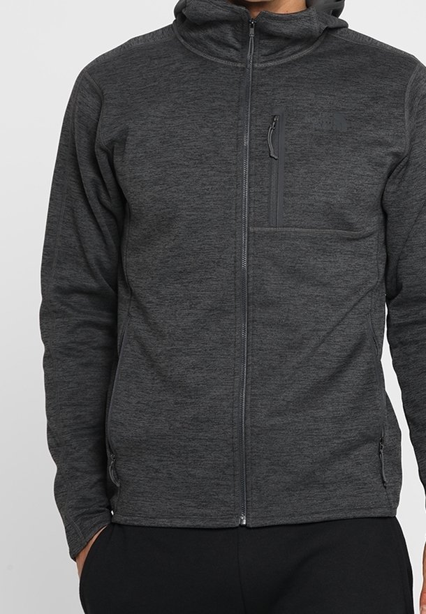 Gray fleece zip-up hoodie with a lined hood, front zipper, and a chest pocket. Features a textured finish and minimal branding.