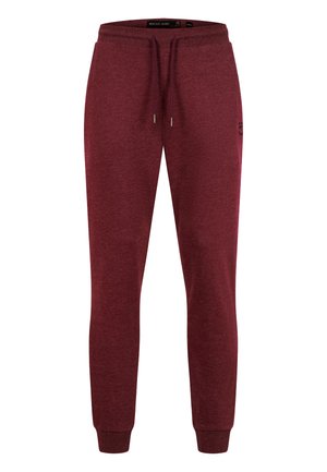 Pantalon jogger slim fit marron avec poignets élastiques, taille à cordon et petit logo sur la partie supérieure de la cuisse gauche.