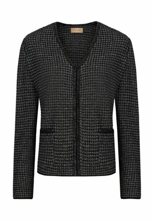 Sorte og hvide struktureret cardigan med V-hals, forlommer og en tætsiddende design. Har en lynlås lukning og lange ærmer.