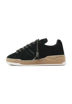 Black suede sneakers with tan rubber sole, featuring grey laces and stitching, round toe, and a subtle side design detail.