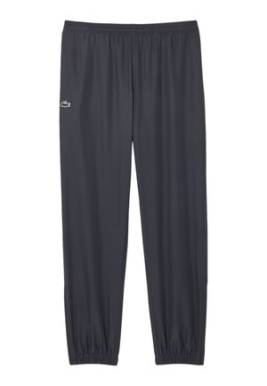 Pantaloni sportivi gri închis, dintr-un material neted, cu un elastic la talie și manșete elastice la glezne. Logo-ul Lacoste pe lateral.